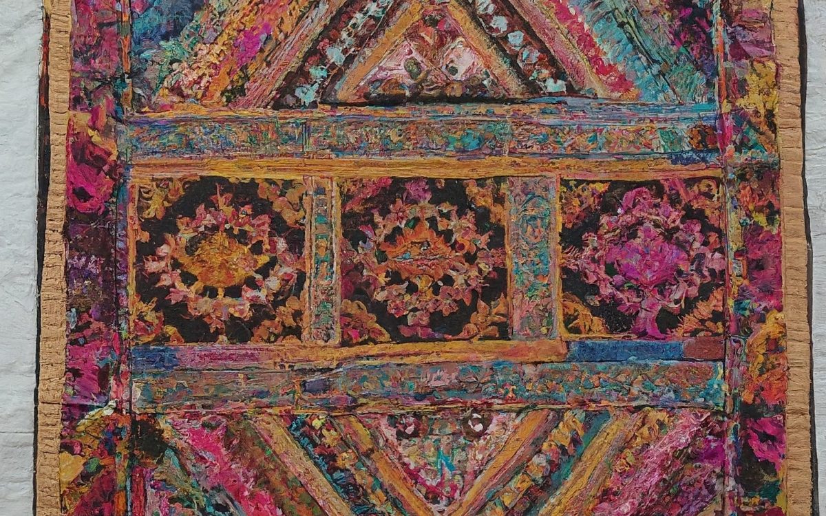 A close-up view of a colorful Indian embroidered tapestry.