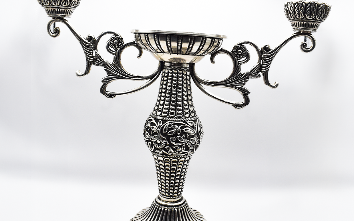  Radiant Silver Candle Holder elegantly placed on a coffee table, enhancing the living room ambiance.