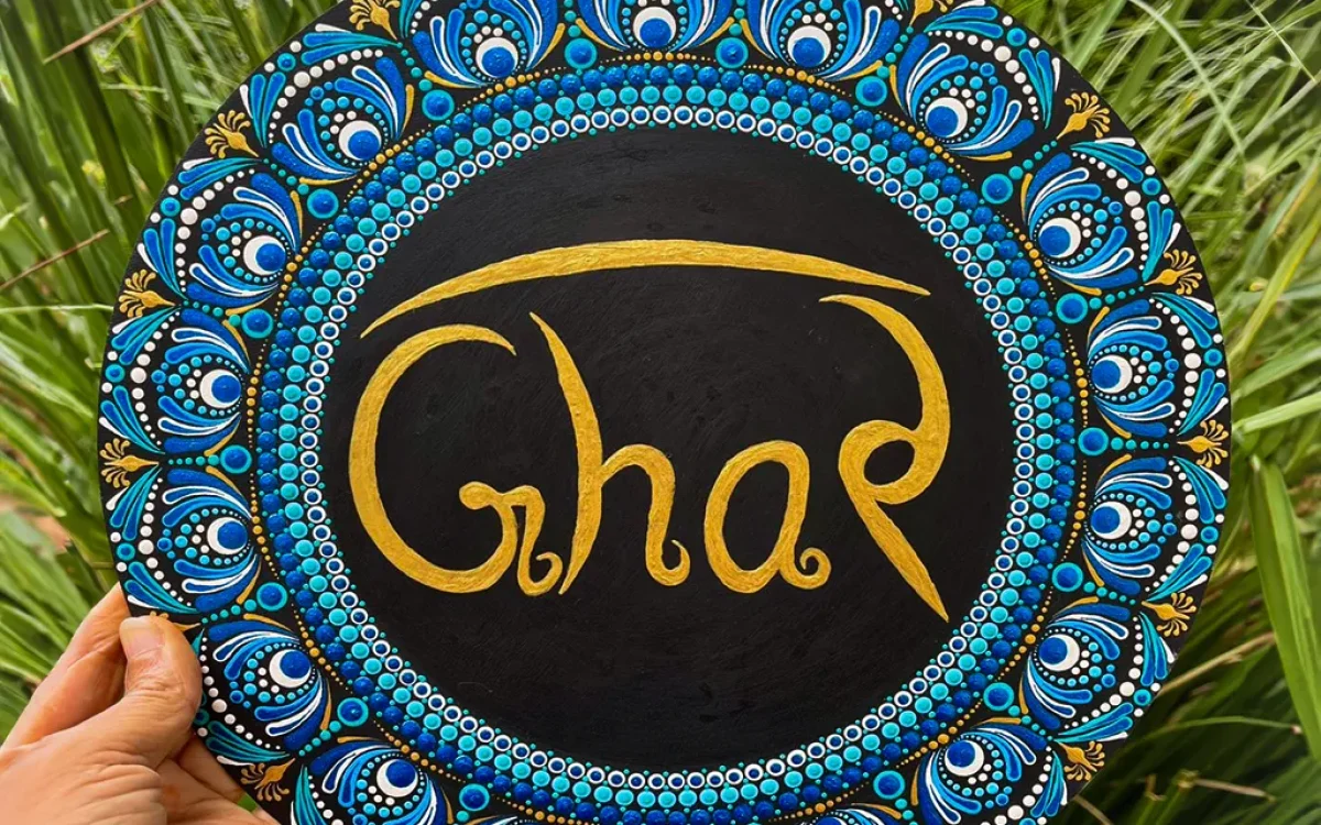 Dot Mandala Ghar Plate showcases the ancient art of dot painting, a technique that requires immense precision and creativity. Each dot is meticulously painted by hand to create stunning mandala patterns that radiate harmony and positivity. The vibrant blue, gold, and white tones are perfectly balanced, giving the plate an elegant yet lively appearance. At the center, the word “Ghar” (meaning “Home” in Hindi) is written in graceful gold lettering, making it a heartwarming symbol of love and belonging.