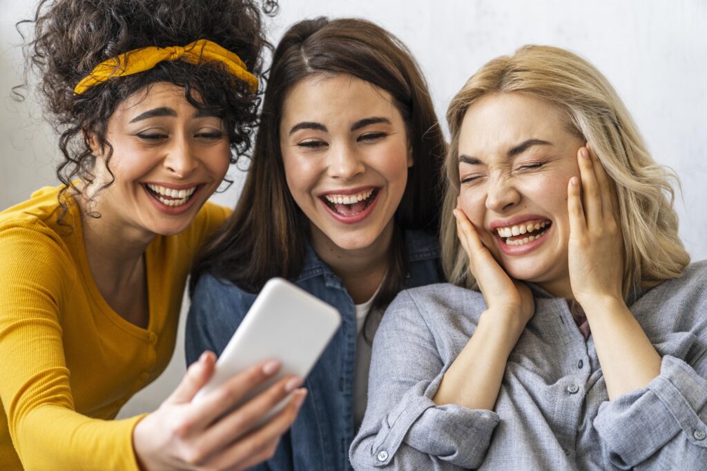 Group of friends laughing and holding phones with the UpSwap app logo displayed.