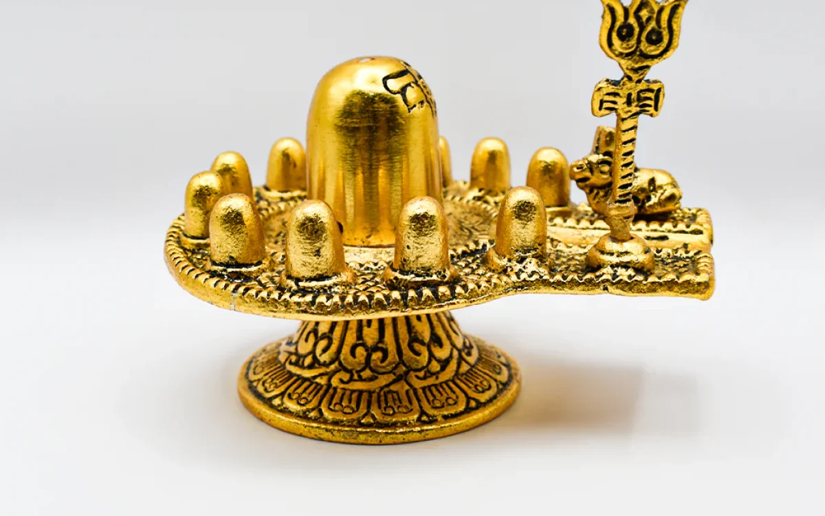 Golden Shiva Lingam emitting radiant energy (depicts a golden Shiva Lingam surrounded by glowing light particles)